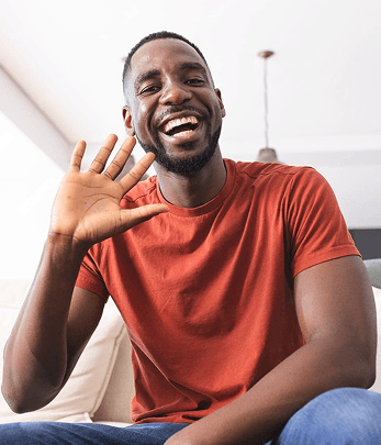 A man waving his hand and laughing