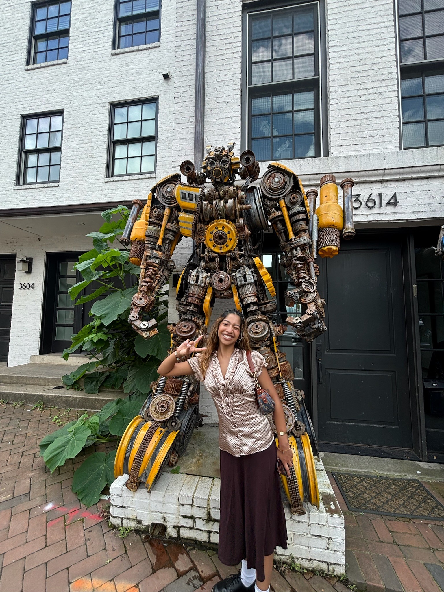 Girl posing in front of a statue