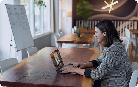 OneSpring team member working at an open cafe.