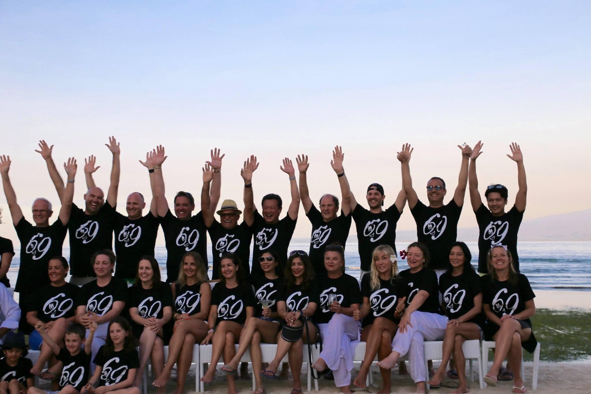 Group standing with arms up 