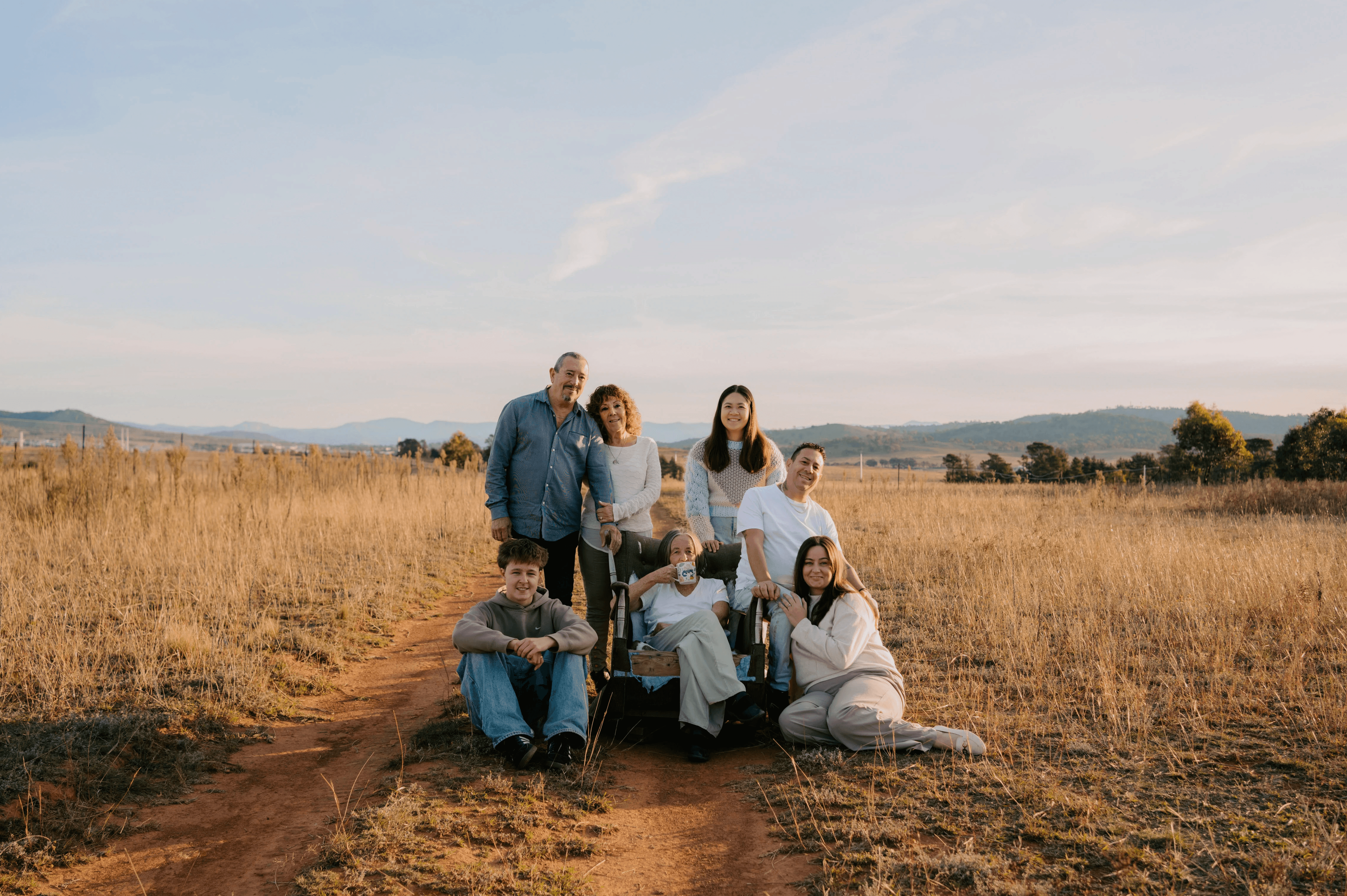 portrait of a family in a dry, grassy field