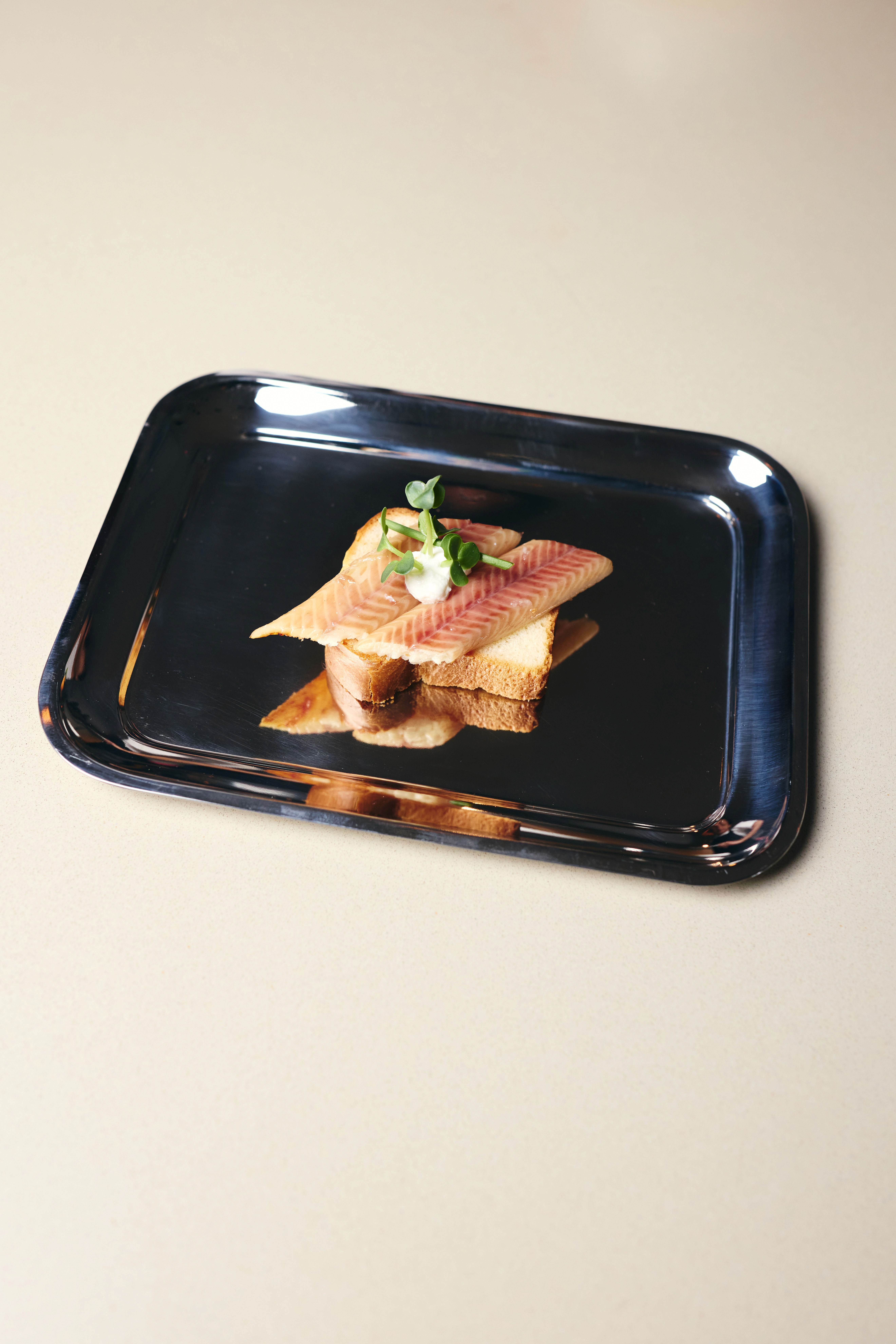 A small candle and paper on a round tray