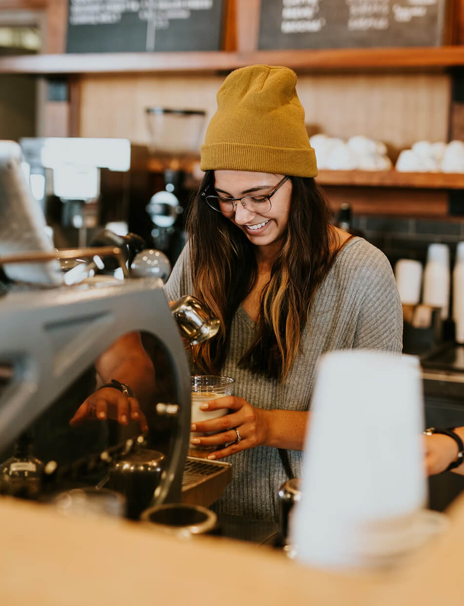 image of a coffee shop owner of a local coffee shop managing his daily work