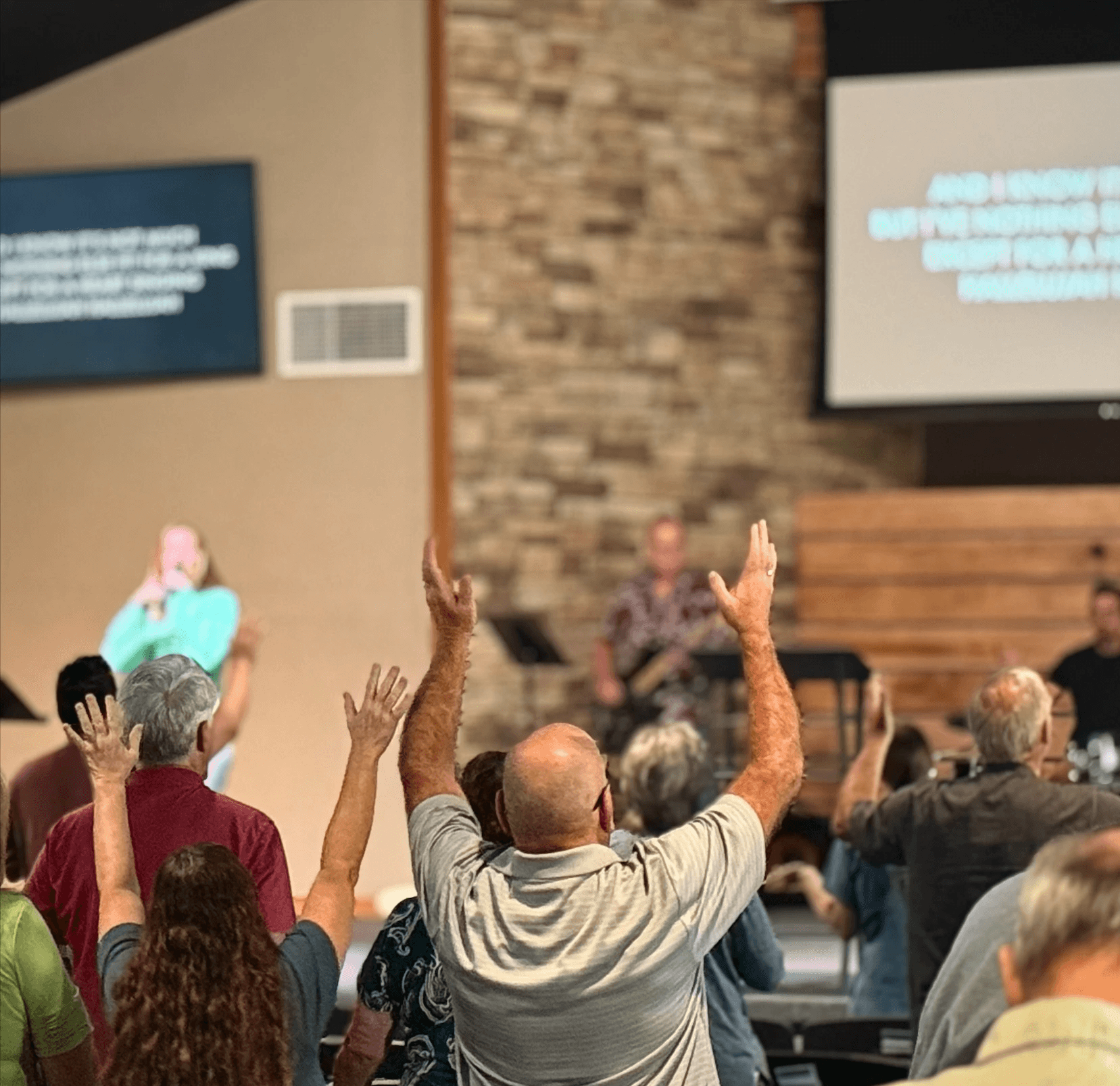 people worshipping before stage