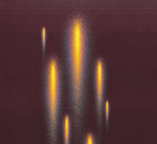 Black cosmetic product bottle against a dark background