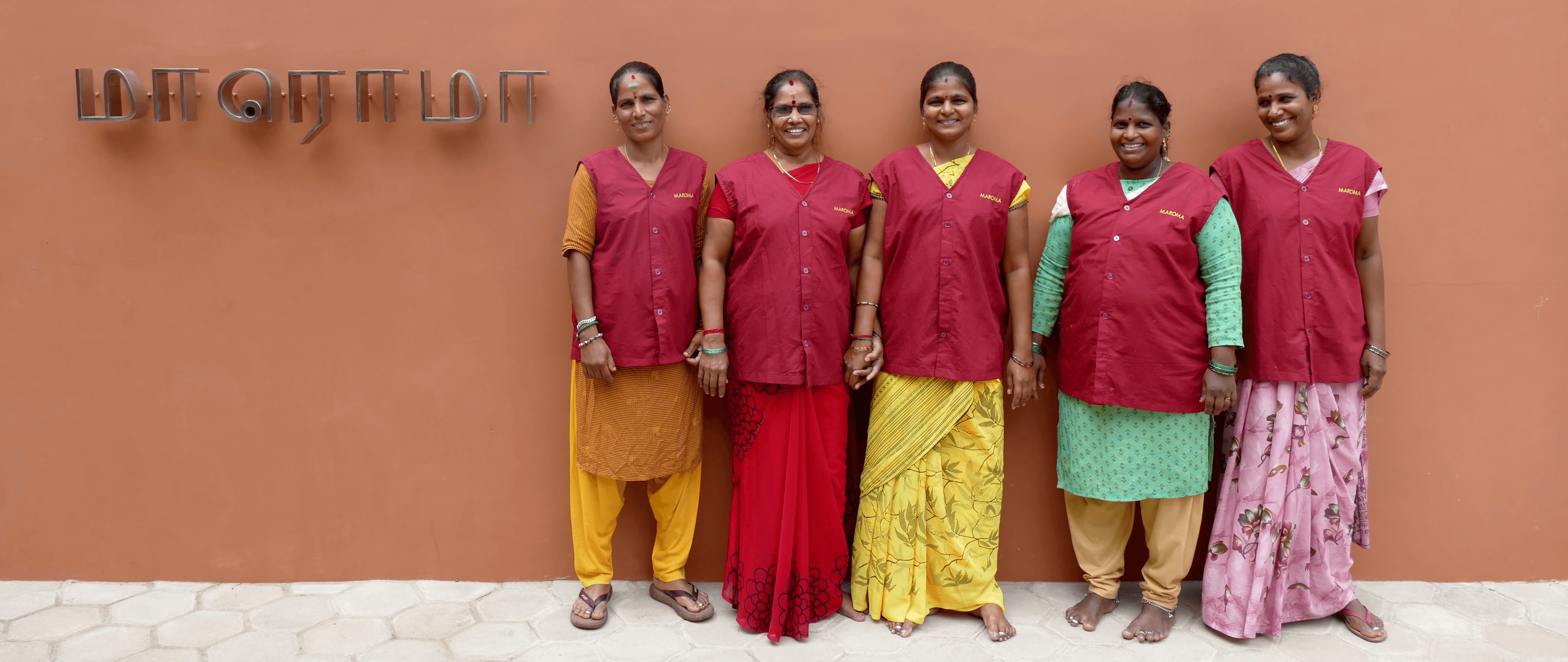 A woman lying down on a soft surface with her eyes closed, bathed in warm sunlight filtering through leaves. Her face has a natural glow, reflecting relaxation and tranquility in a serene spa-like setting.