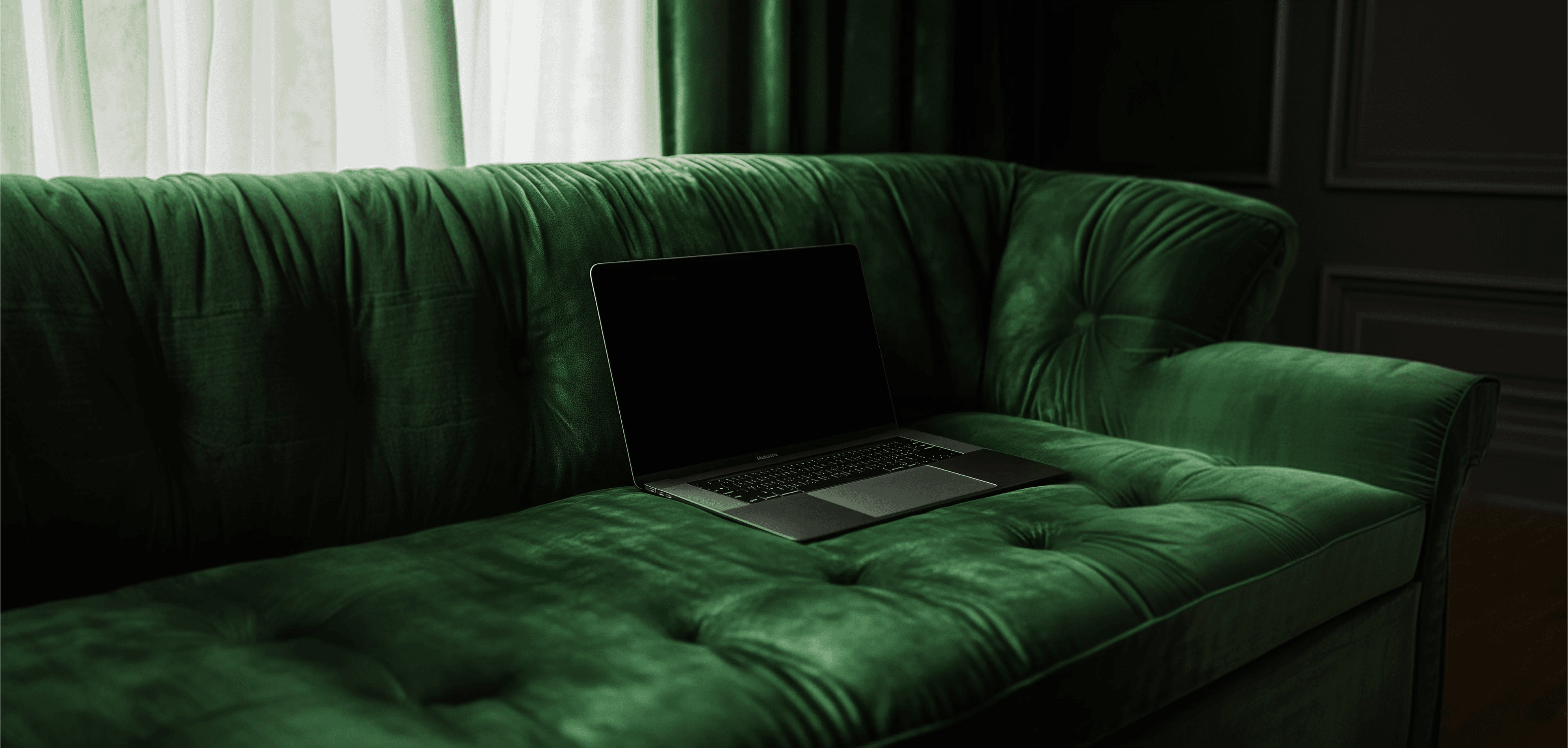 Image of a laptop on a green sofa
