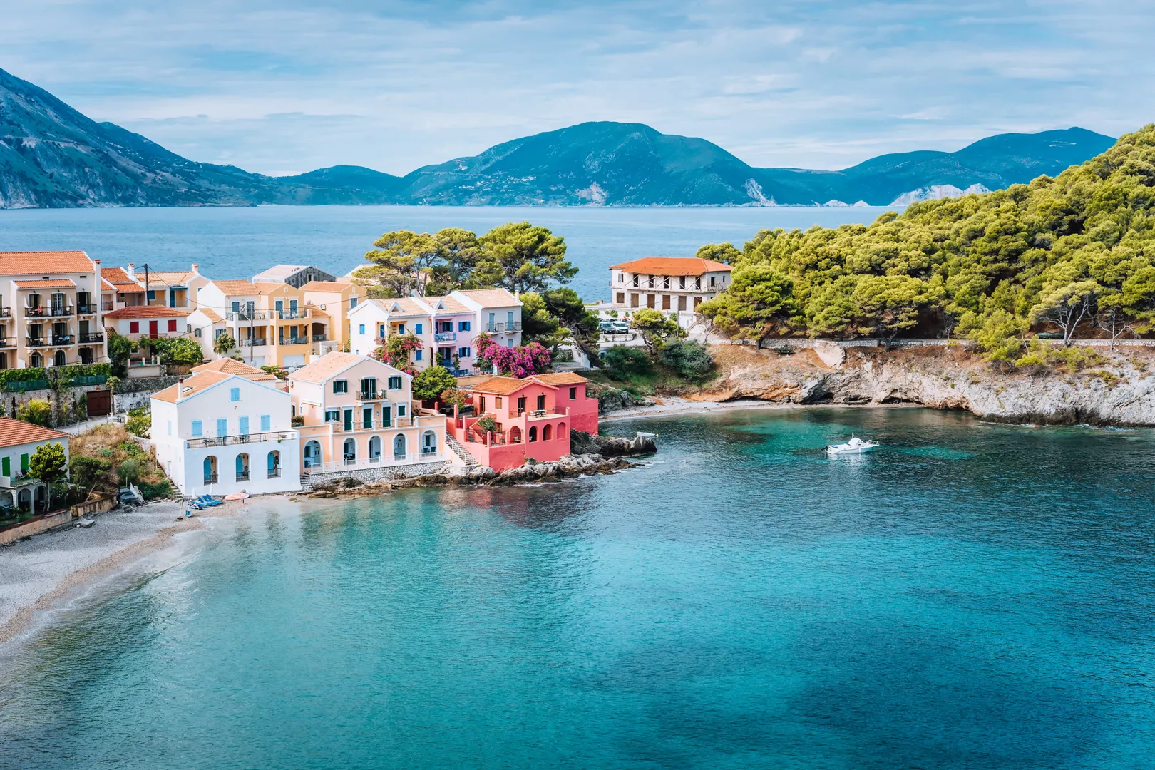 A colourful Mediterranean village above a turquoise bay