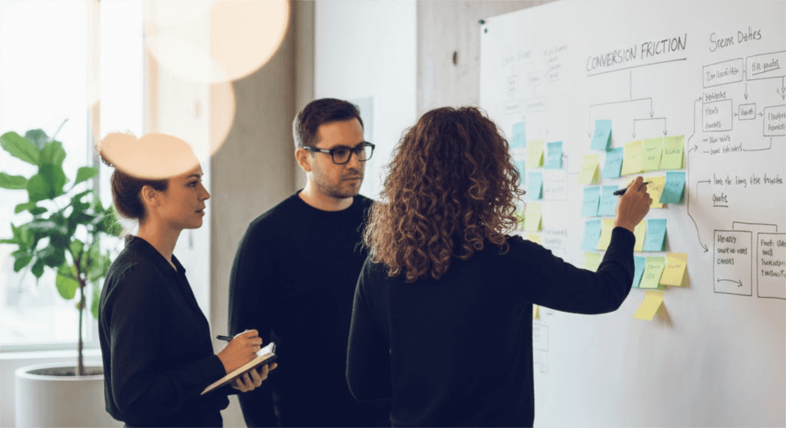 Team talking over customer insights in an open bright office.