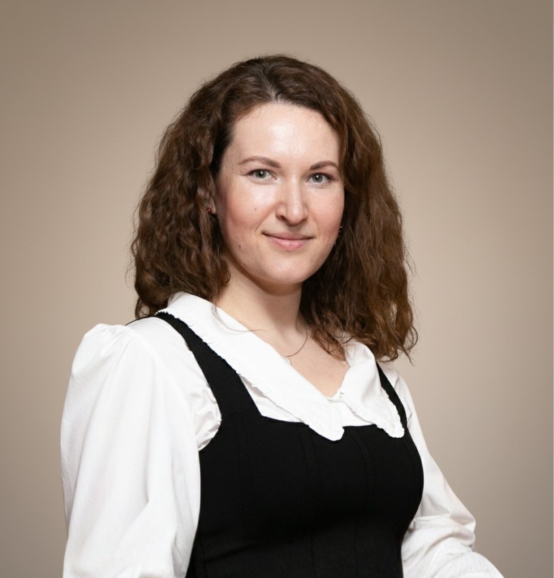 woman in brown coat using macbook air