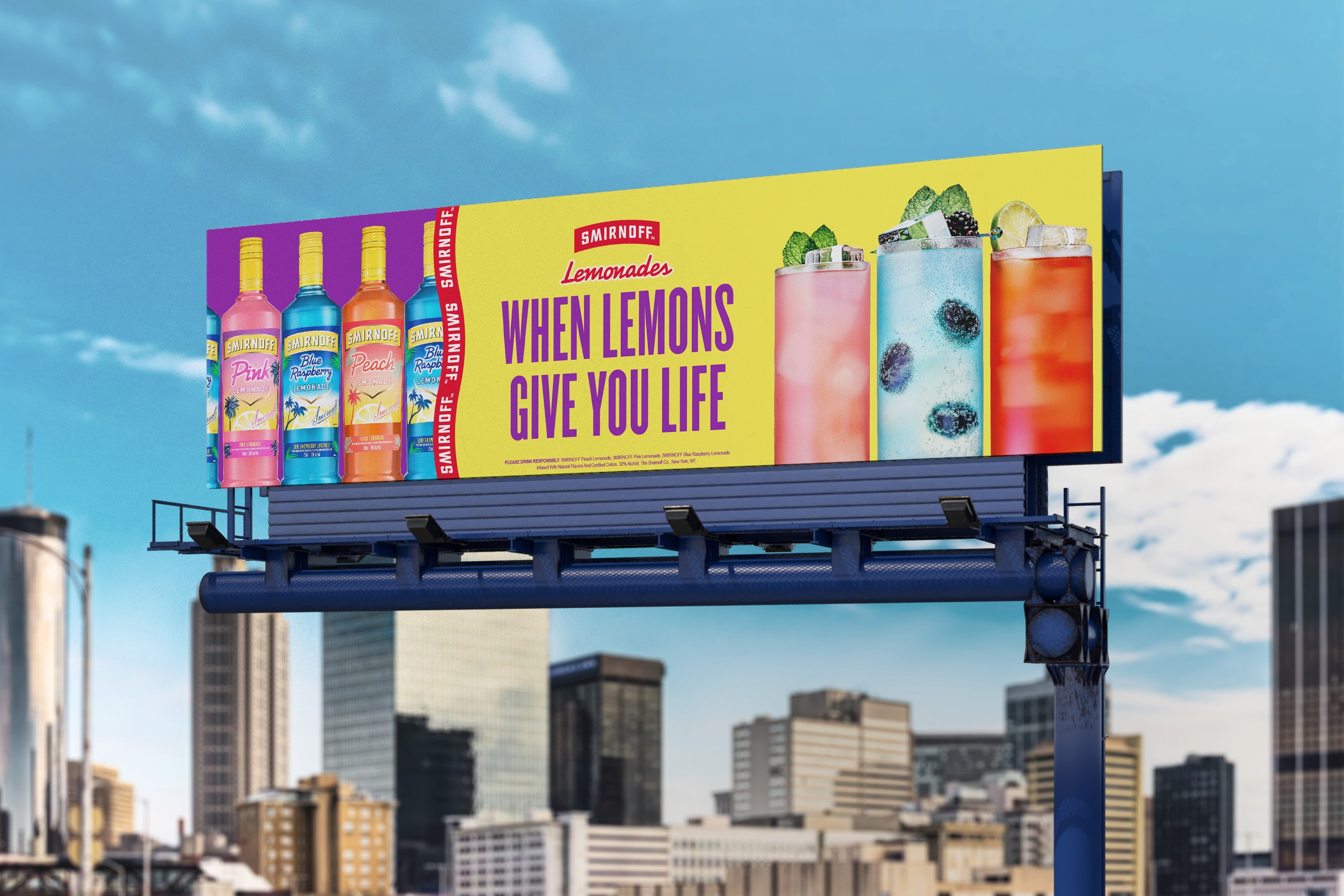 A colorful Smirnoff Lemonade billboard advertisement against a city backdrop, featuring a trio of flavored drinks beside matching colored bottles, garnished with lemon and mint, with the playful tagline, "WHEN LEMONS GIVE YOU LIFE."