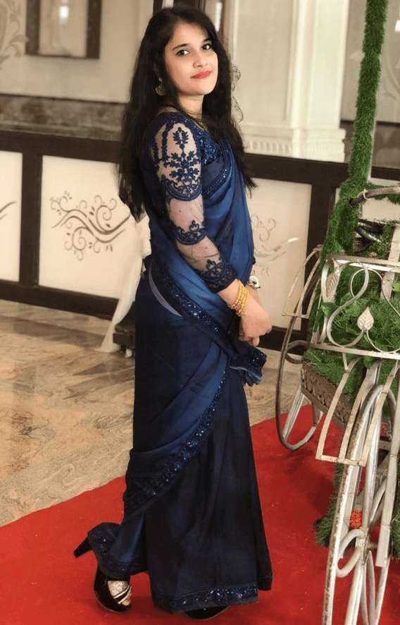 Close-up of a dark green leaf showing its textured surface and central vein against a muted background.