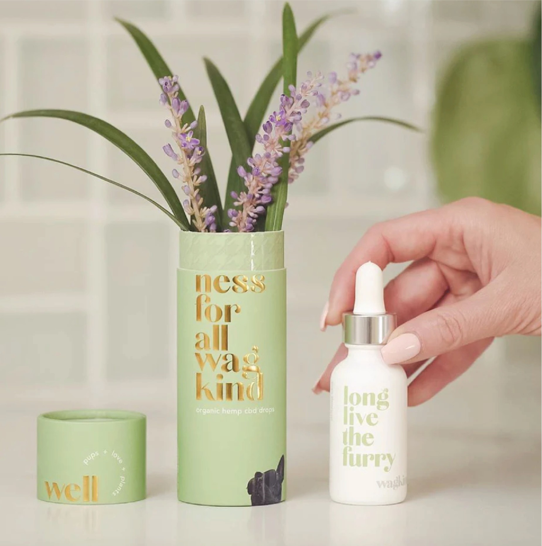 Editorial portrait of a bald model with a white clay mask on face and body, neutral backdrop.
