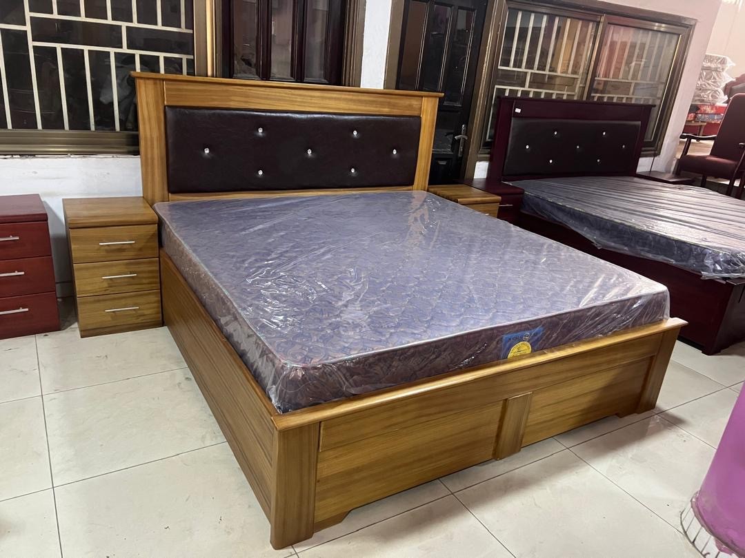 a gray couch with a wooden base on a gray background