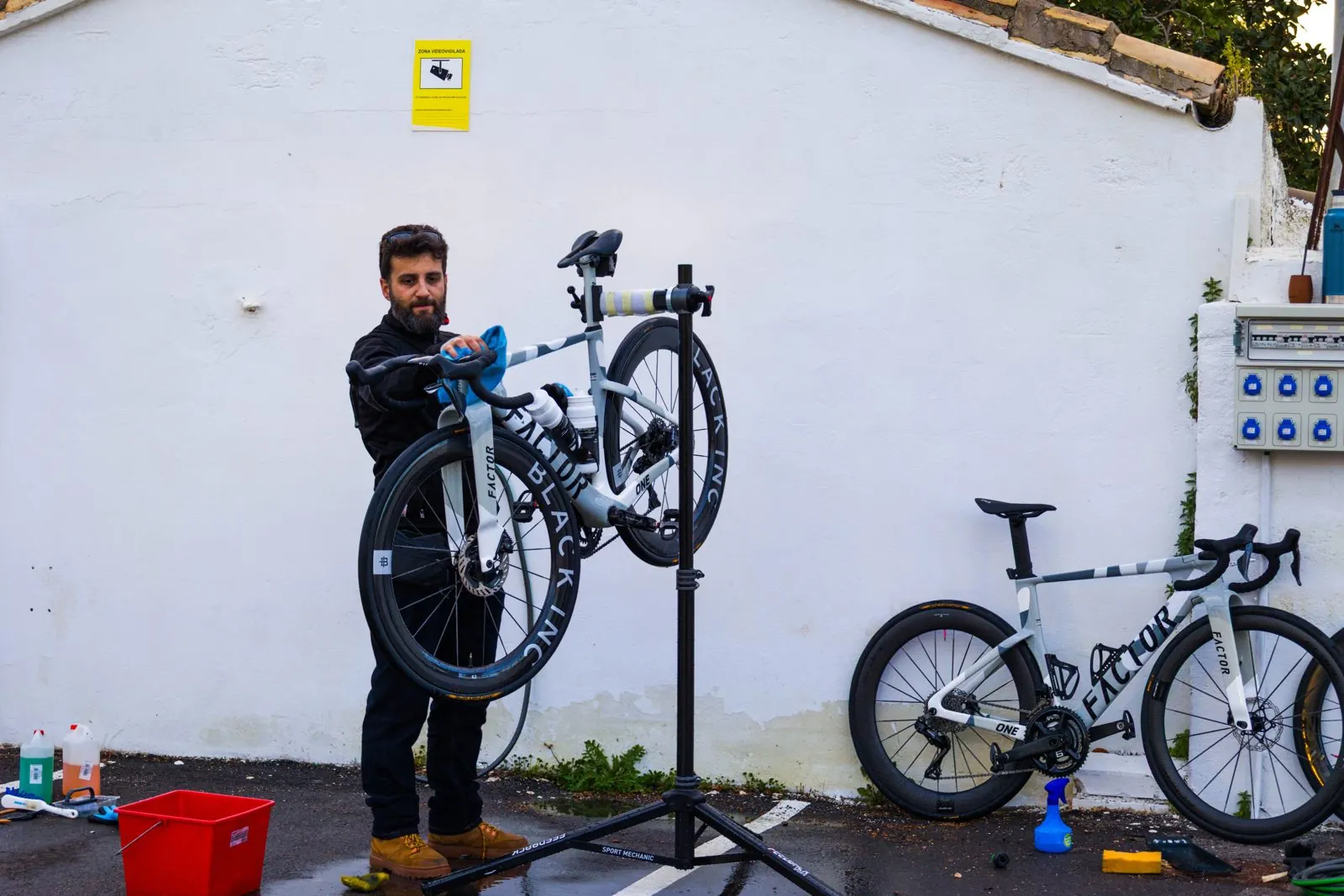 The reset cc mechanic working on a team bike at the Millars camp