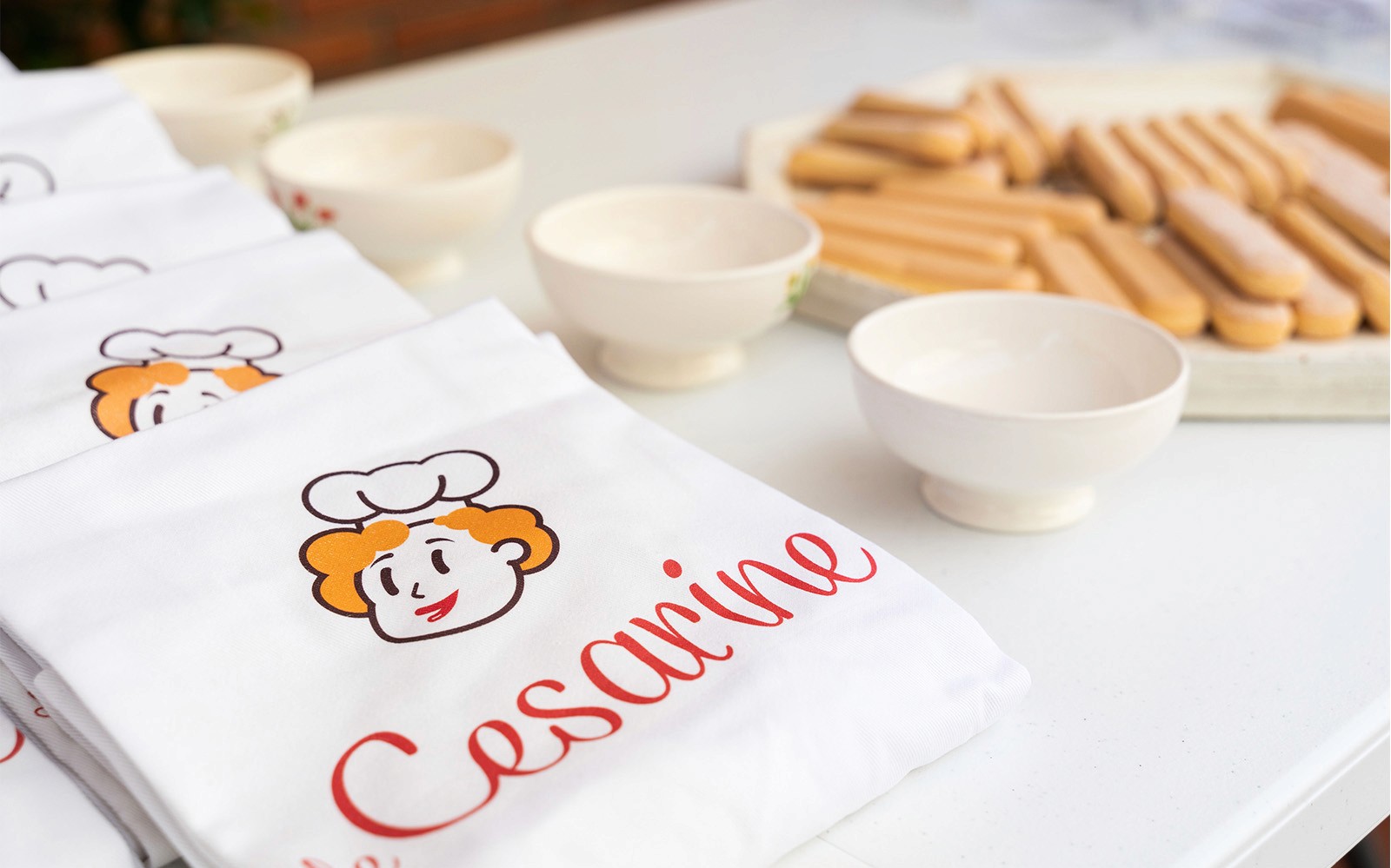Aprons and bowls set up for a private cooking class in Milan.