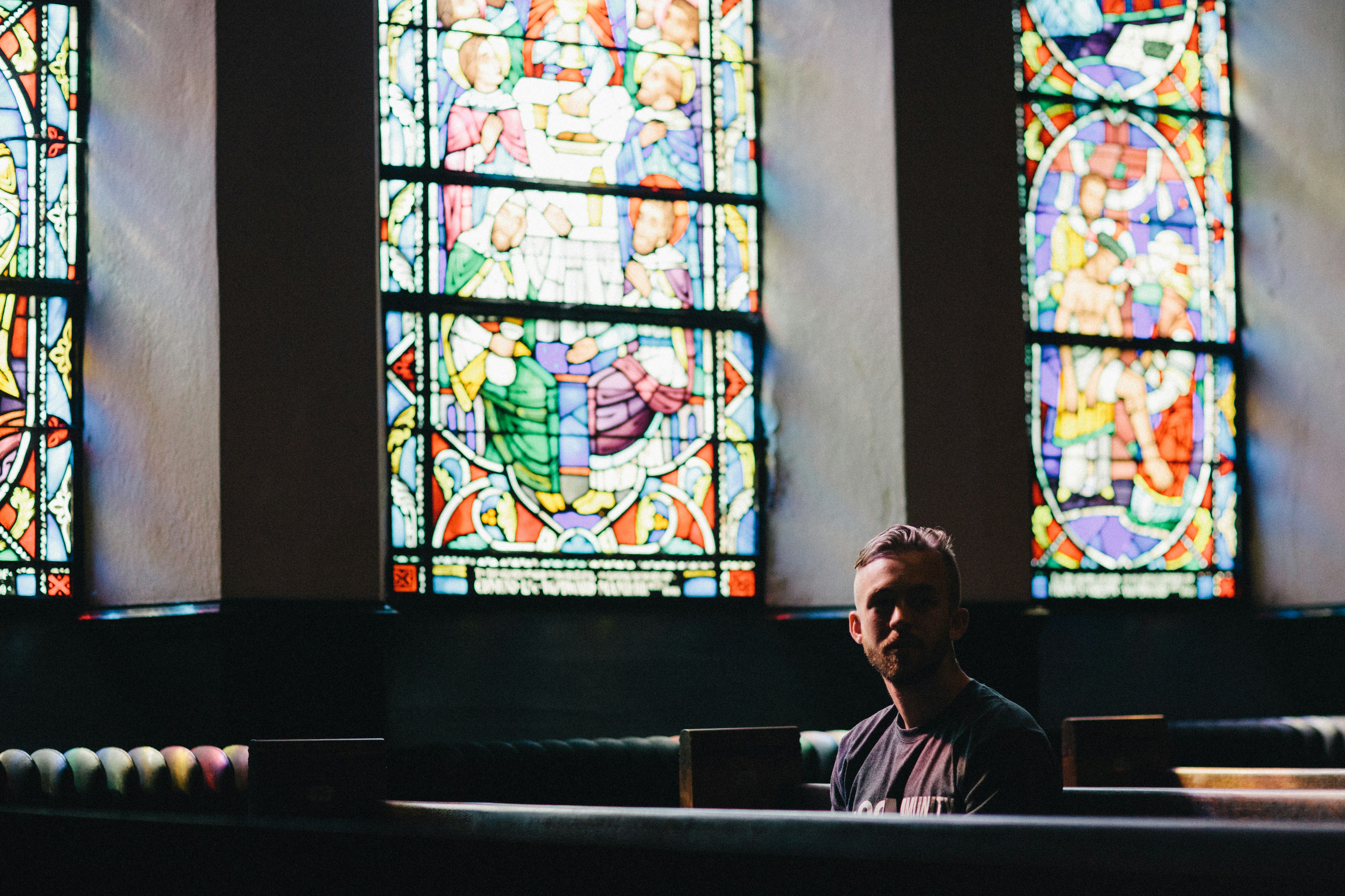 man sitting in pew