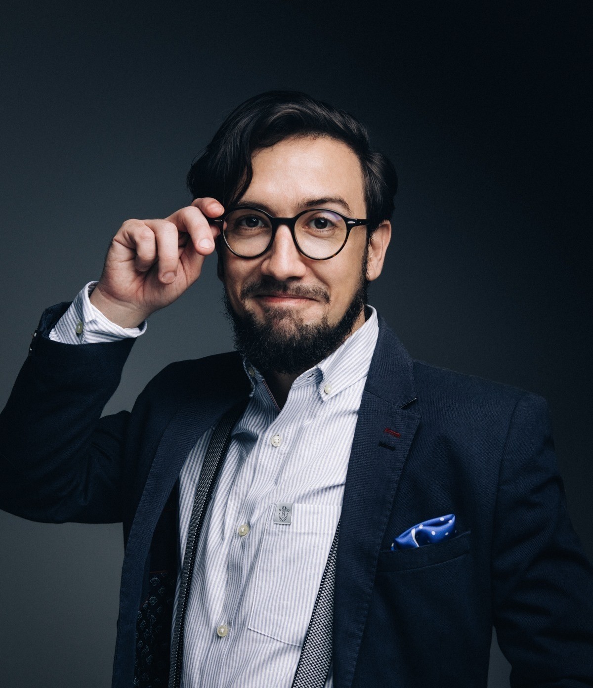 A woman with straight blonde hair wearing a light colored sweater looks away.
