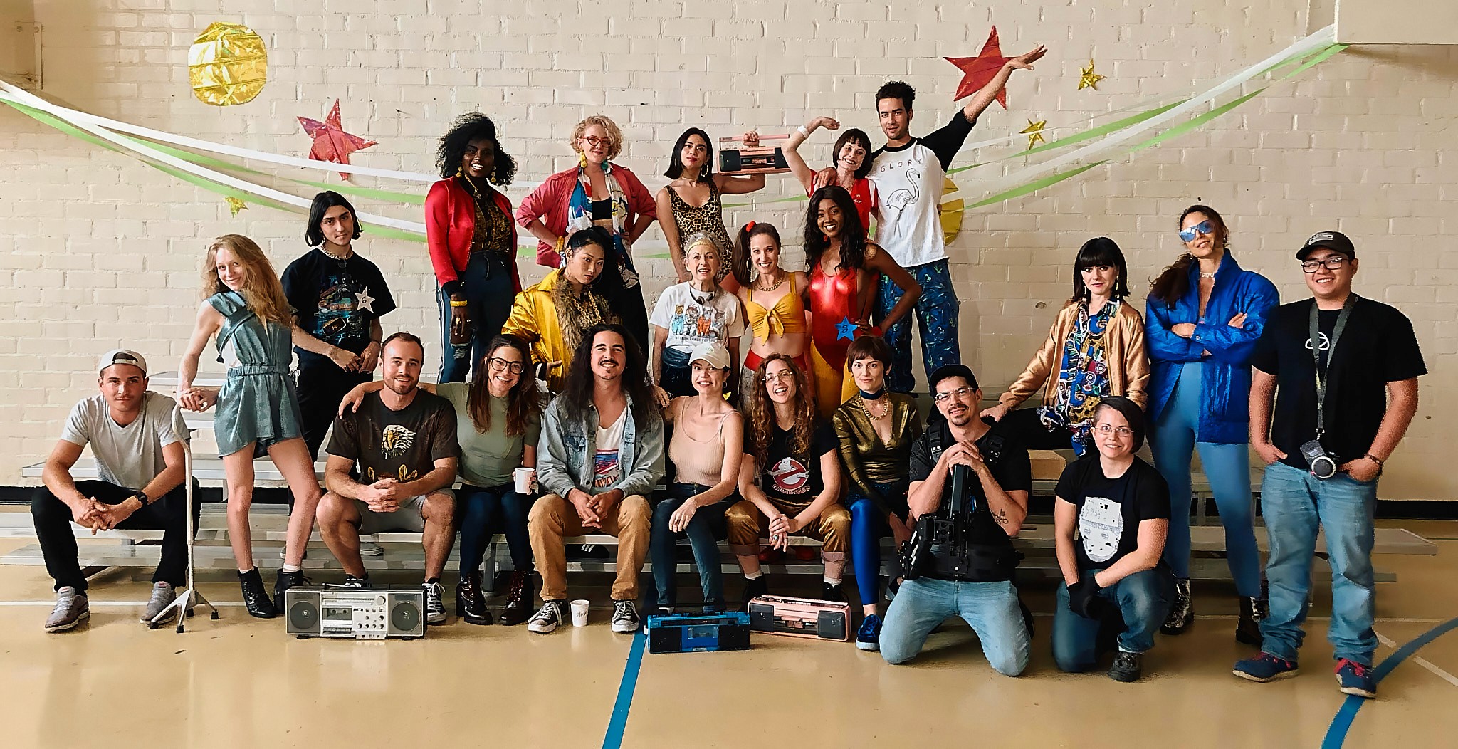 Three people sitting on a couch in a room looking at mobile devices