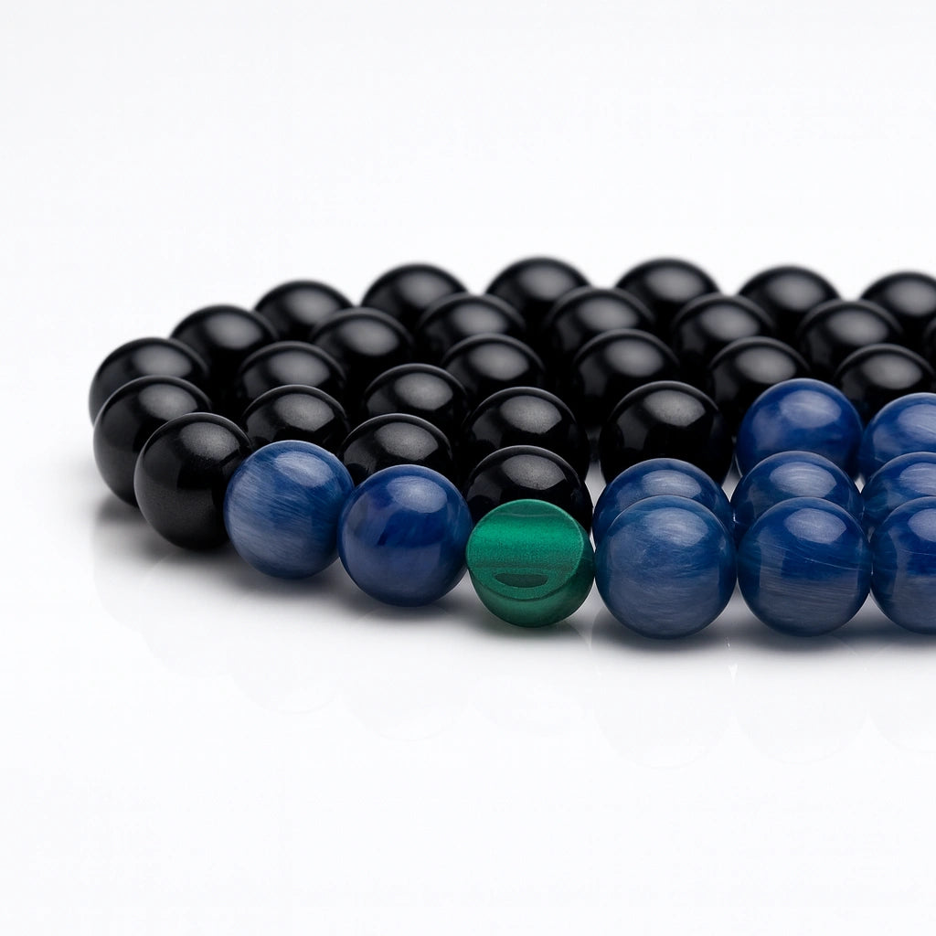 Beaded bracelet with black, blue, and green beads on a white background