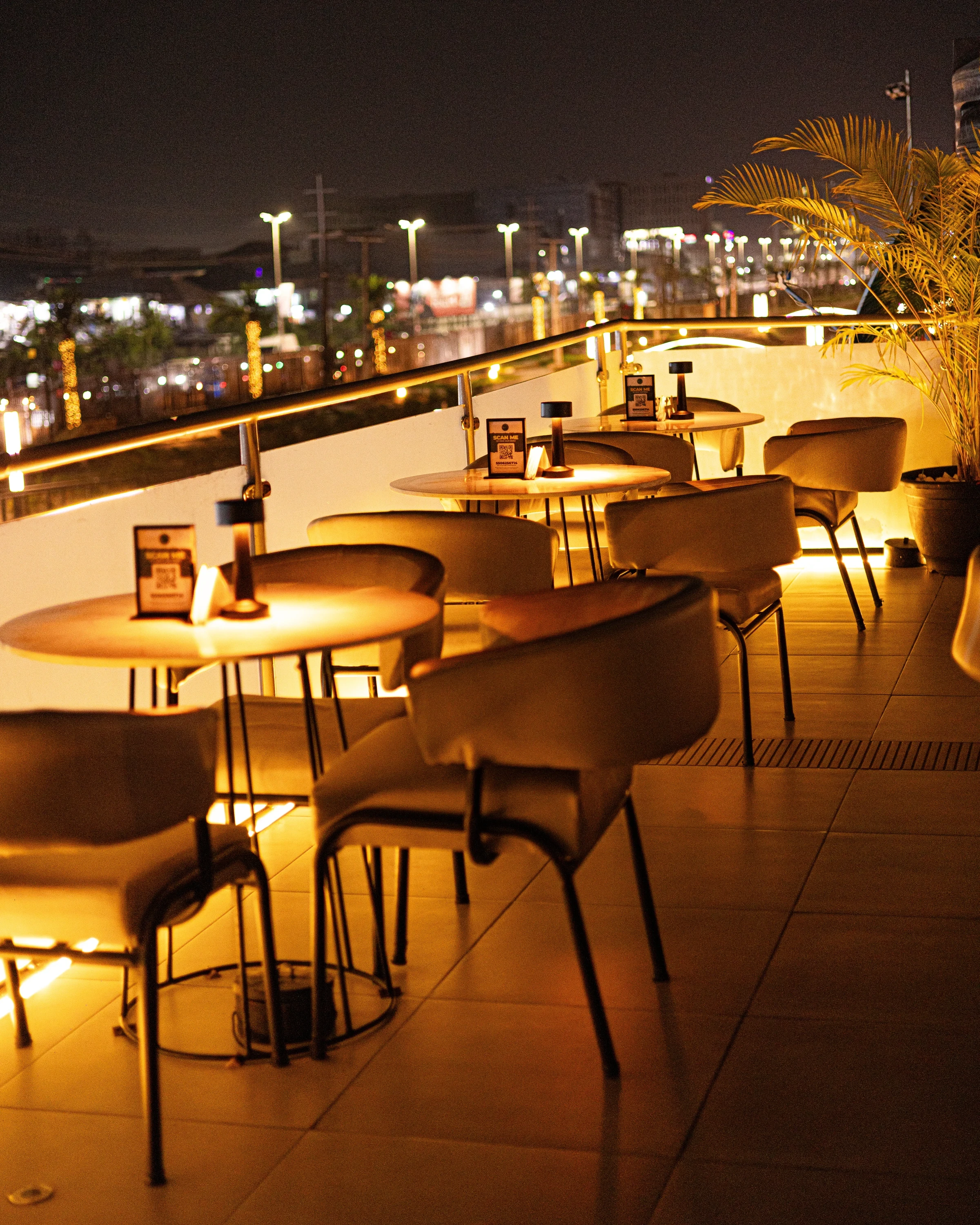 Elegant rooftop dining room at NO.5 Lounge & Restaurant with tables prepared for guests
