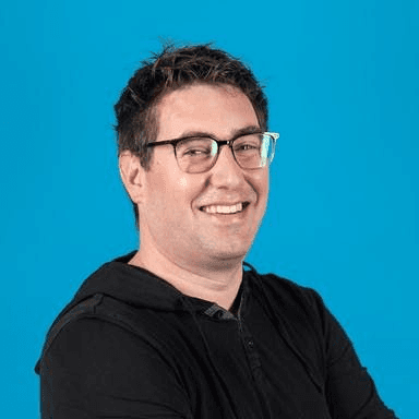 Black and white portrait of a smiling person with curly hair