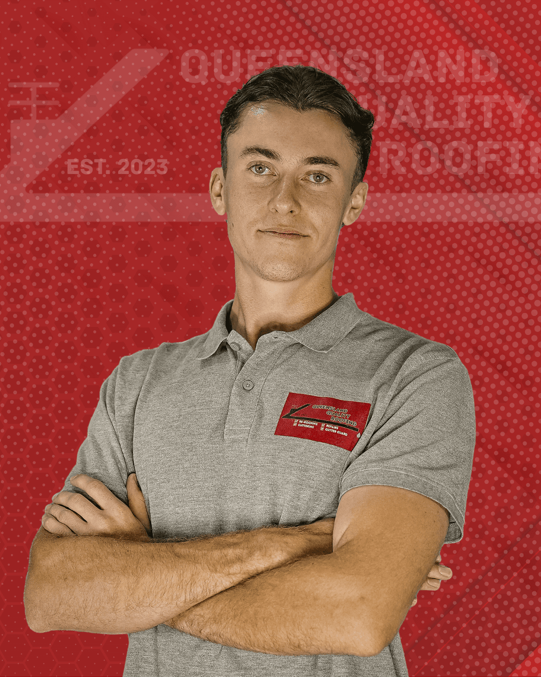 Ricky Javsnik, Founder of Queensland Quality Roofing, standing outdoors in a grey company polo shirt with arms crossed, smiling confidently. A trusted roofing expert in Brisbane, dedicated to craftsmanship, transparency, and delivering high-quality roofing solutions across Southeast Queensland.