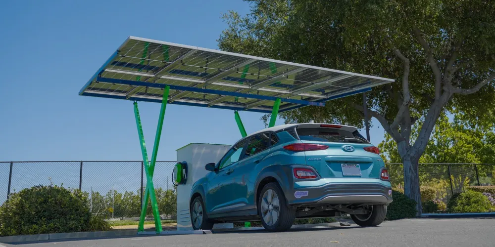 a blue car parked in front of a gas station