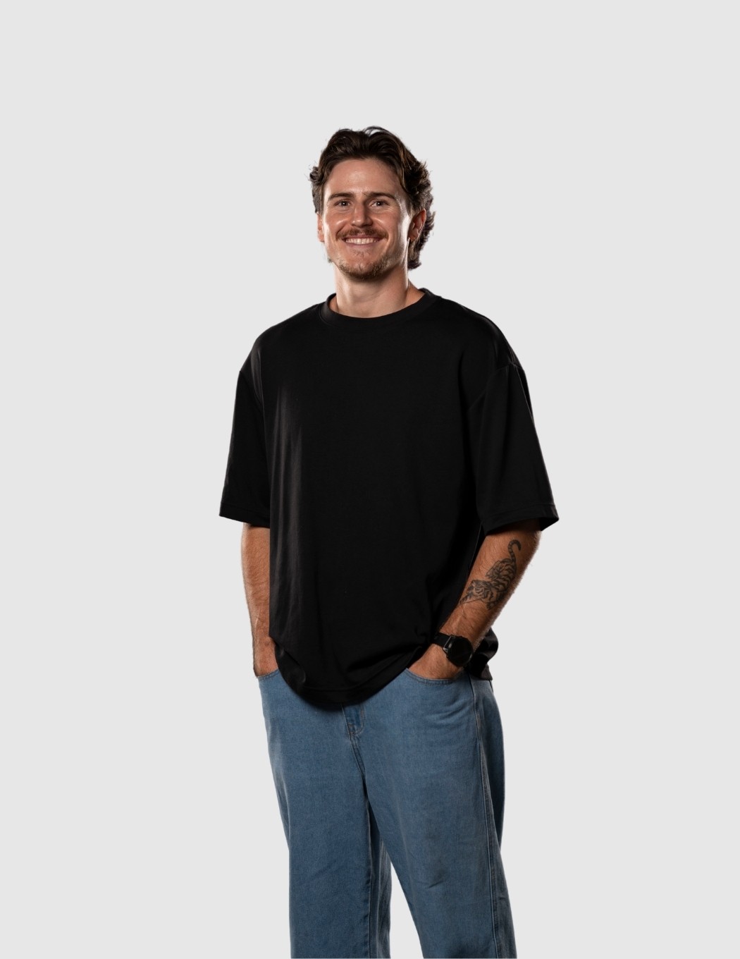 Bailey smiling with hands in pockets