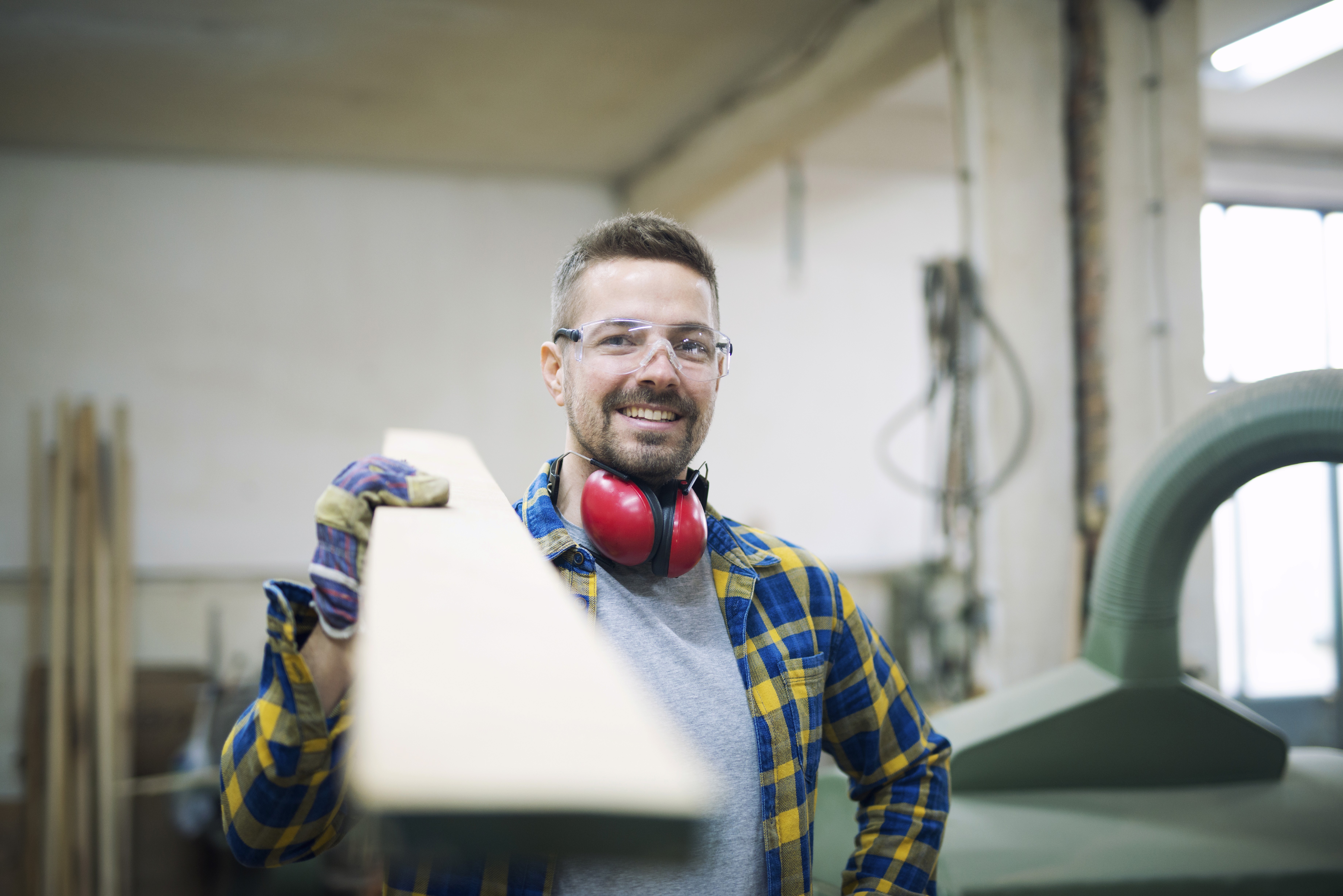 man holding orange angle grinder