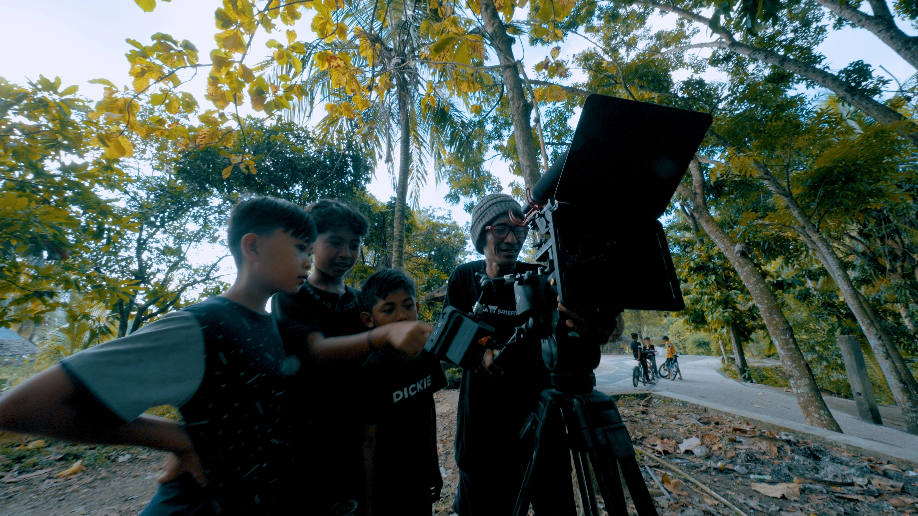 a couple of local children learn filming