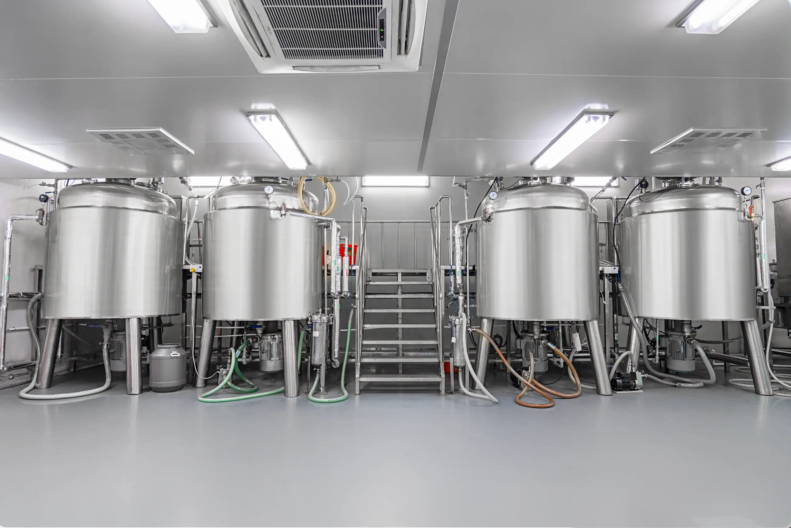 Industrial stainless steel mixing tanks at JIAH factory for bulk liquid soap and hotel body wash manufacturing.