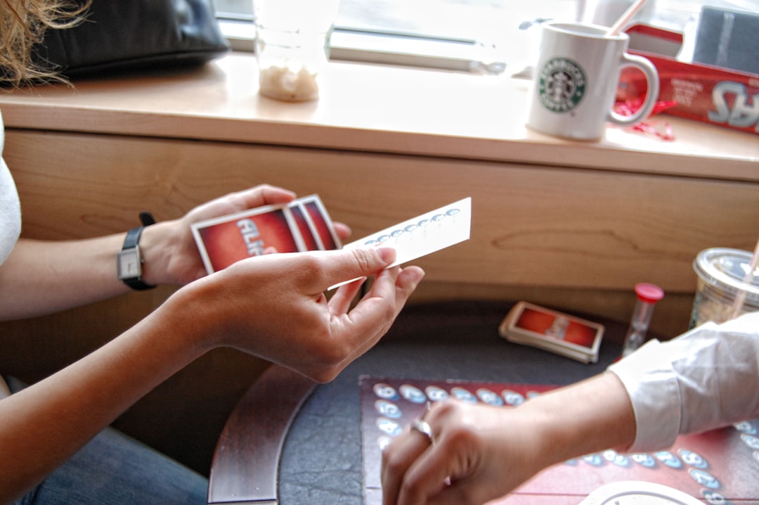 Two people sitting at a table playing a game