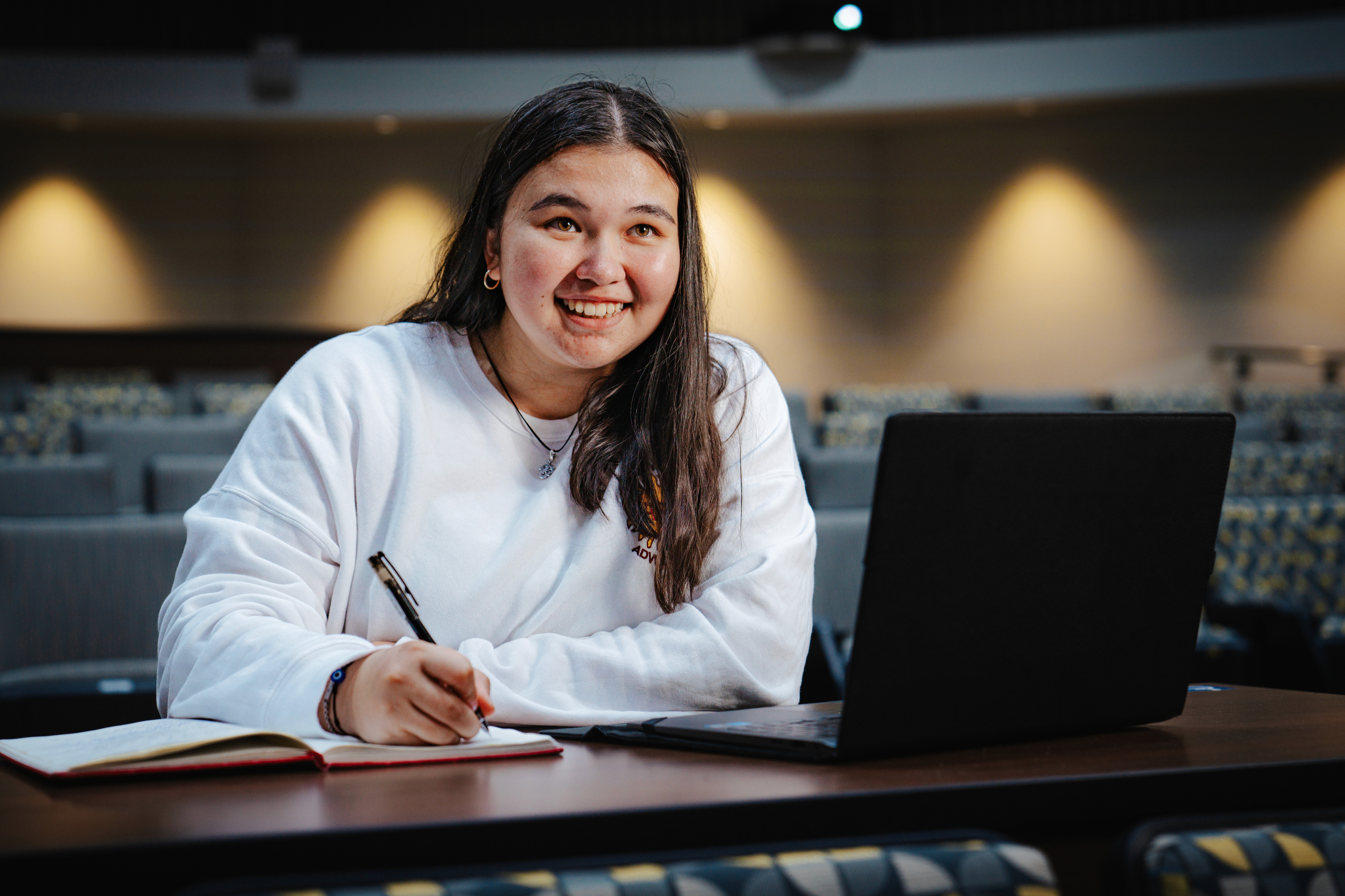 Student with a laptop wearing an Arizona State sweatshirt