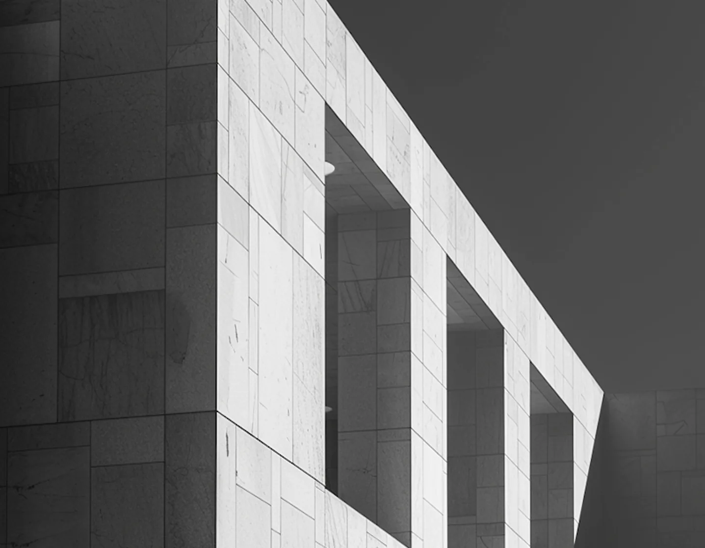 Monochrome photograph of a white stone building facade