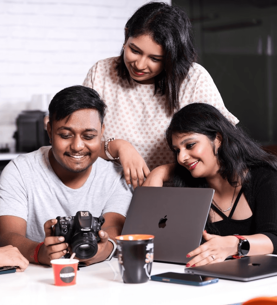 Hand holding a spinning sneaker against red background