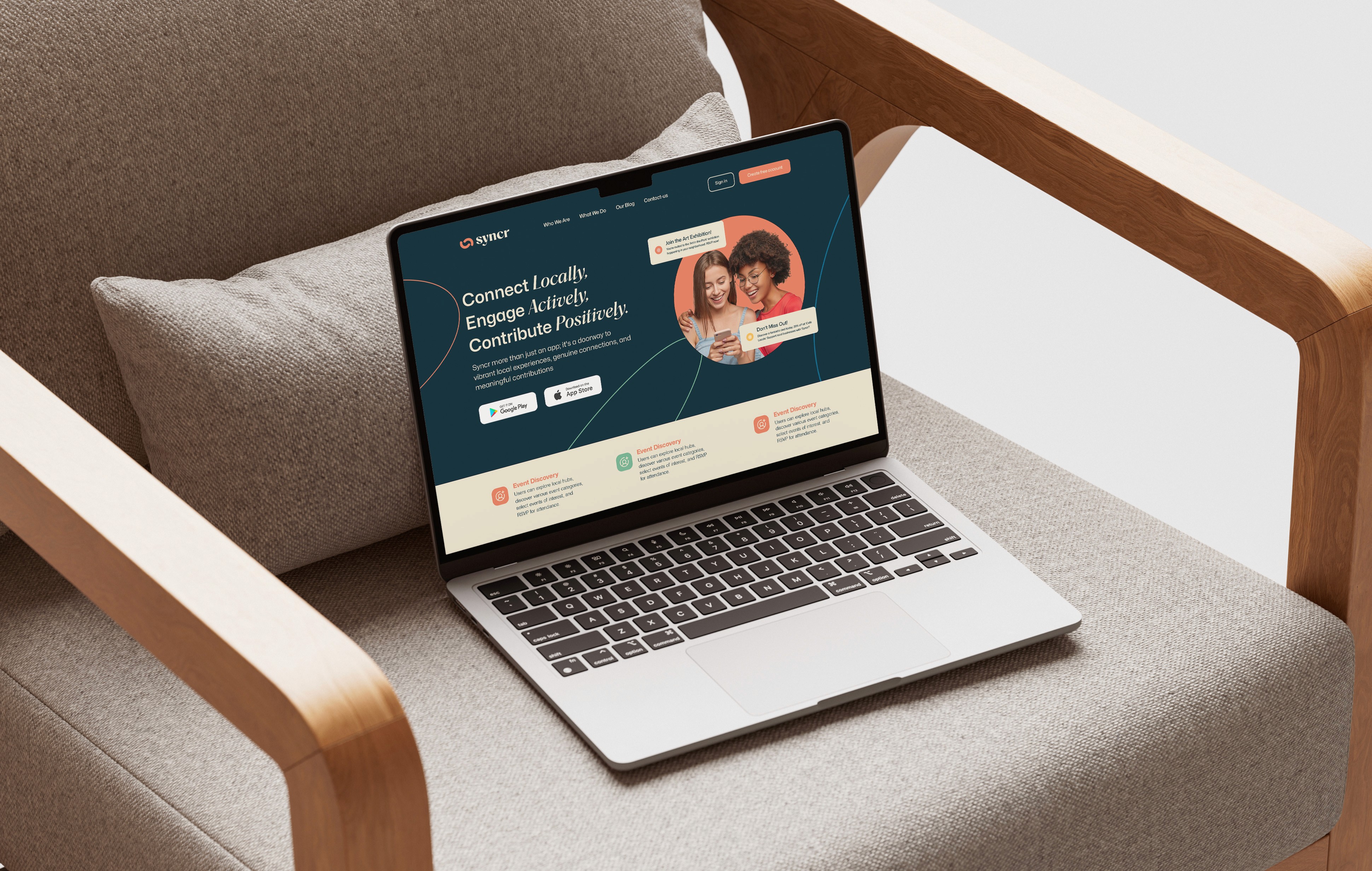 A laptop sitting on an armchair displaying a community-focused website with images of people and feature descriptions.