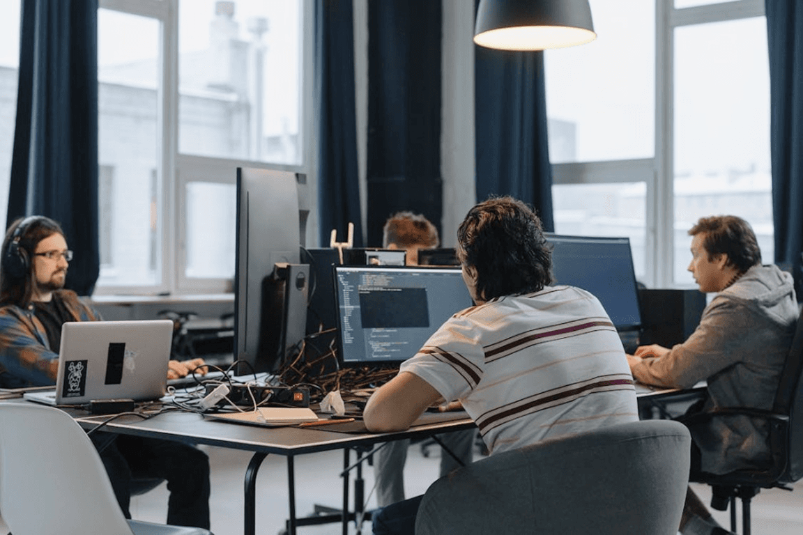 Software development team working on healthcare app code in an office, representing healthcare app development cost considerations in 2026