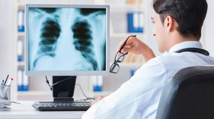 doctor looking at imaging before sending feedback to patient