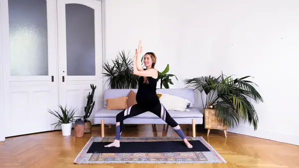Pregnant woman in a prop-supported yoga stretch – Day 7 prenatal yoga to boost energy and address pregnancy fatigue through slow flow and gentle poses