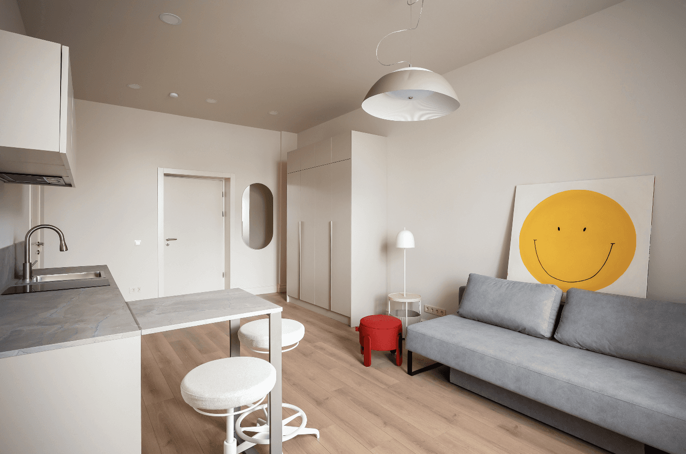 A tranquil view of a luxurious villa with a pool overlooking a serene lake, surrounded by lush greenery.