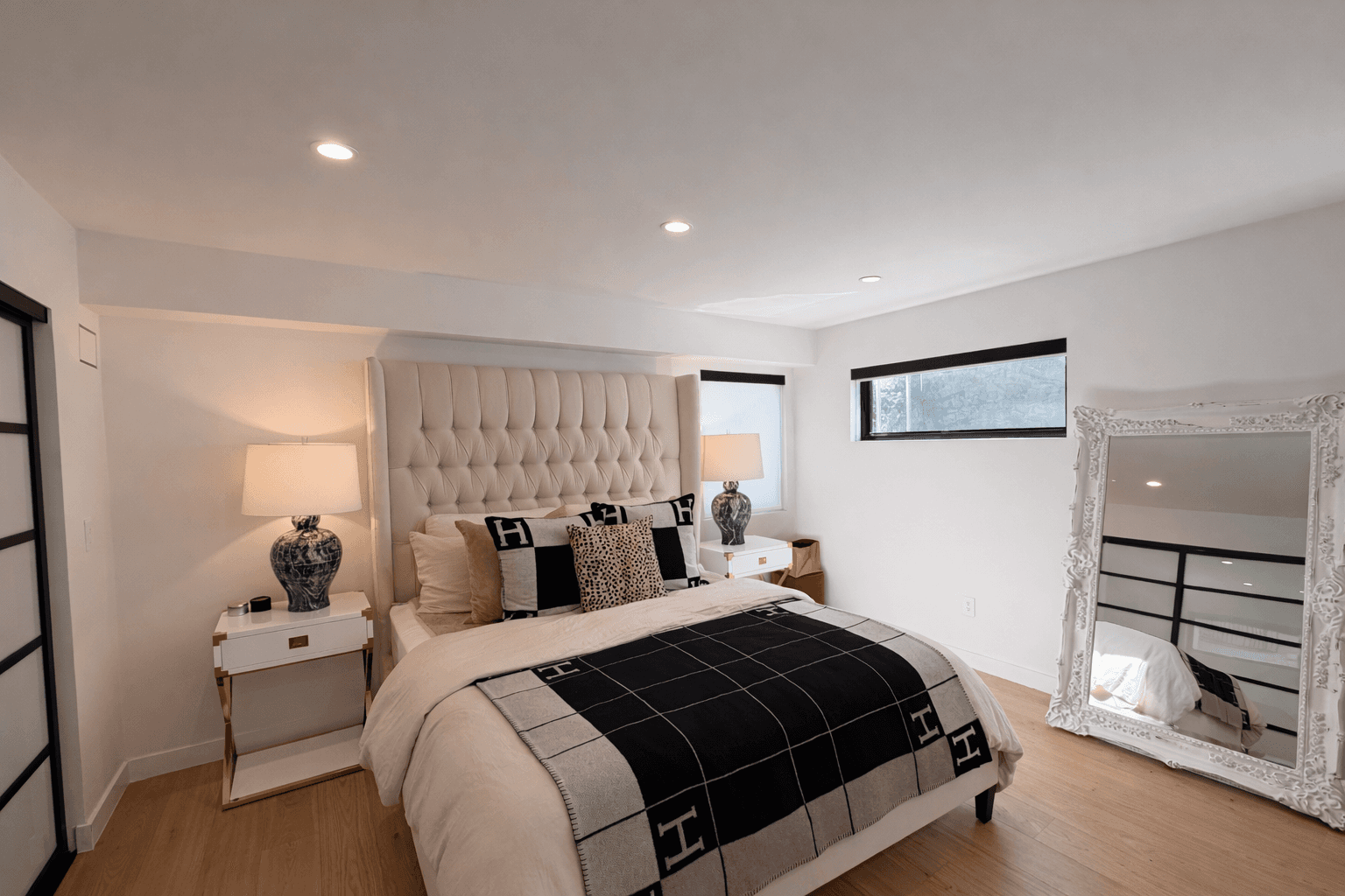 Bright bedroom with colorful bedspread and wall art