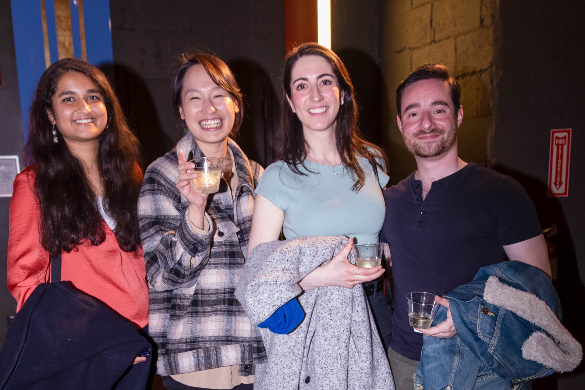 a group of students smiling for the camera in the SVA Theatre lobby after the Venture Forum