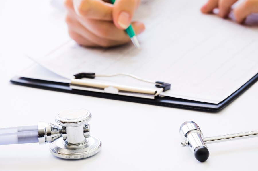 A doctor prescribing medicines to his patient.