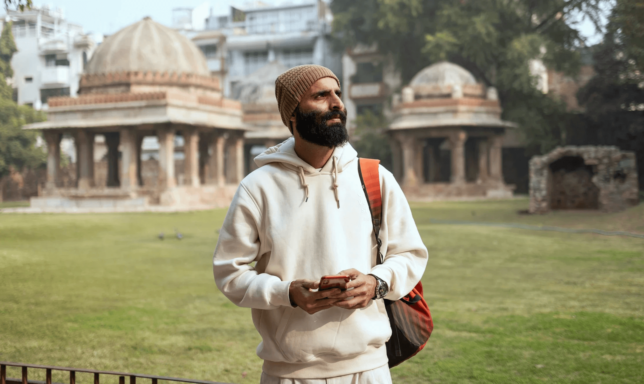 tourist looks into distance with historic buildings nearby