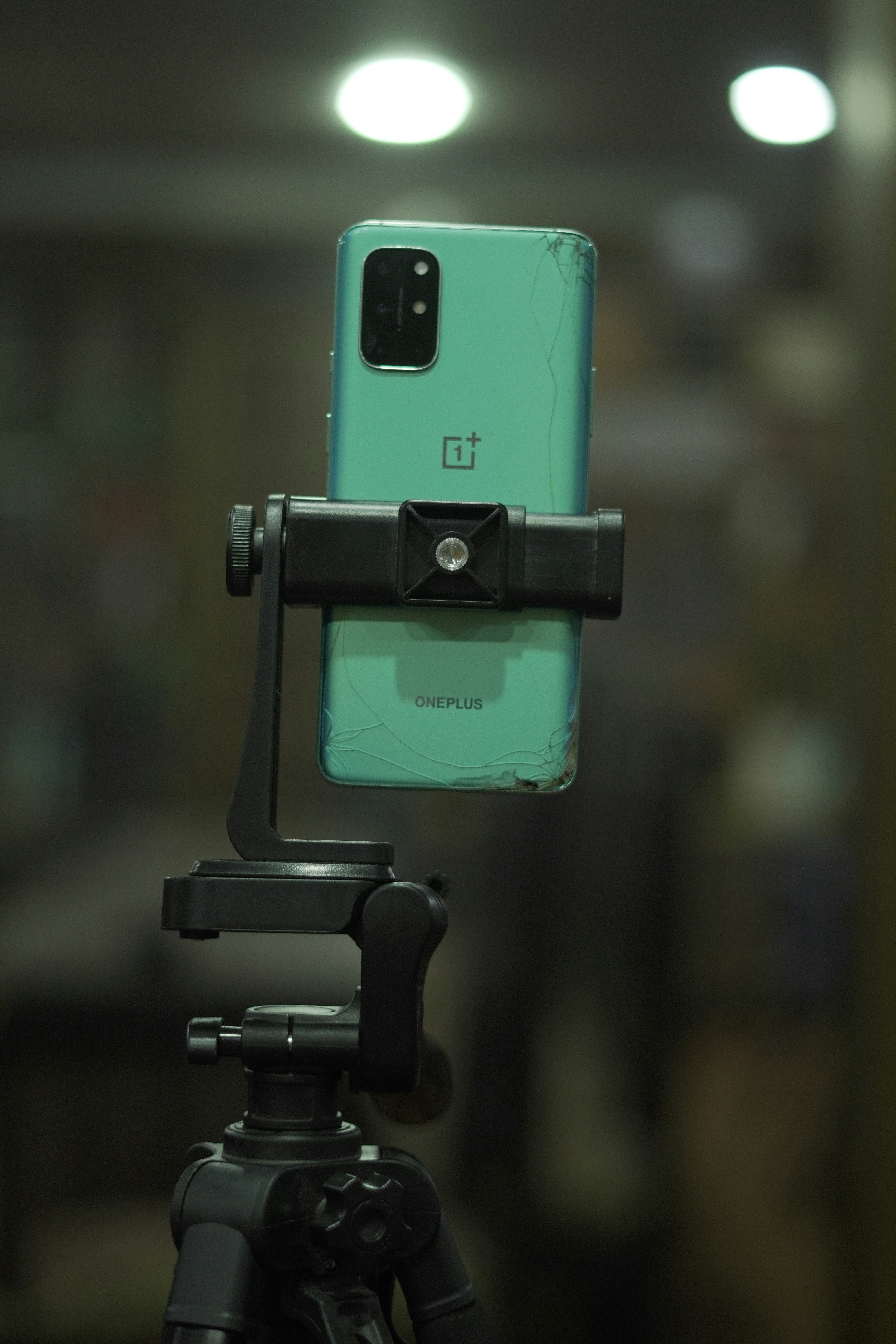 Smartphone mounted on a tripod with adjustable arm.