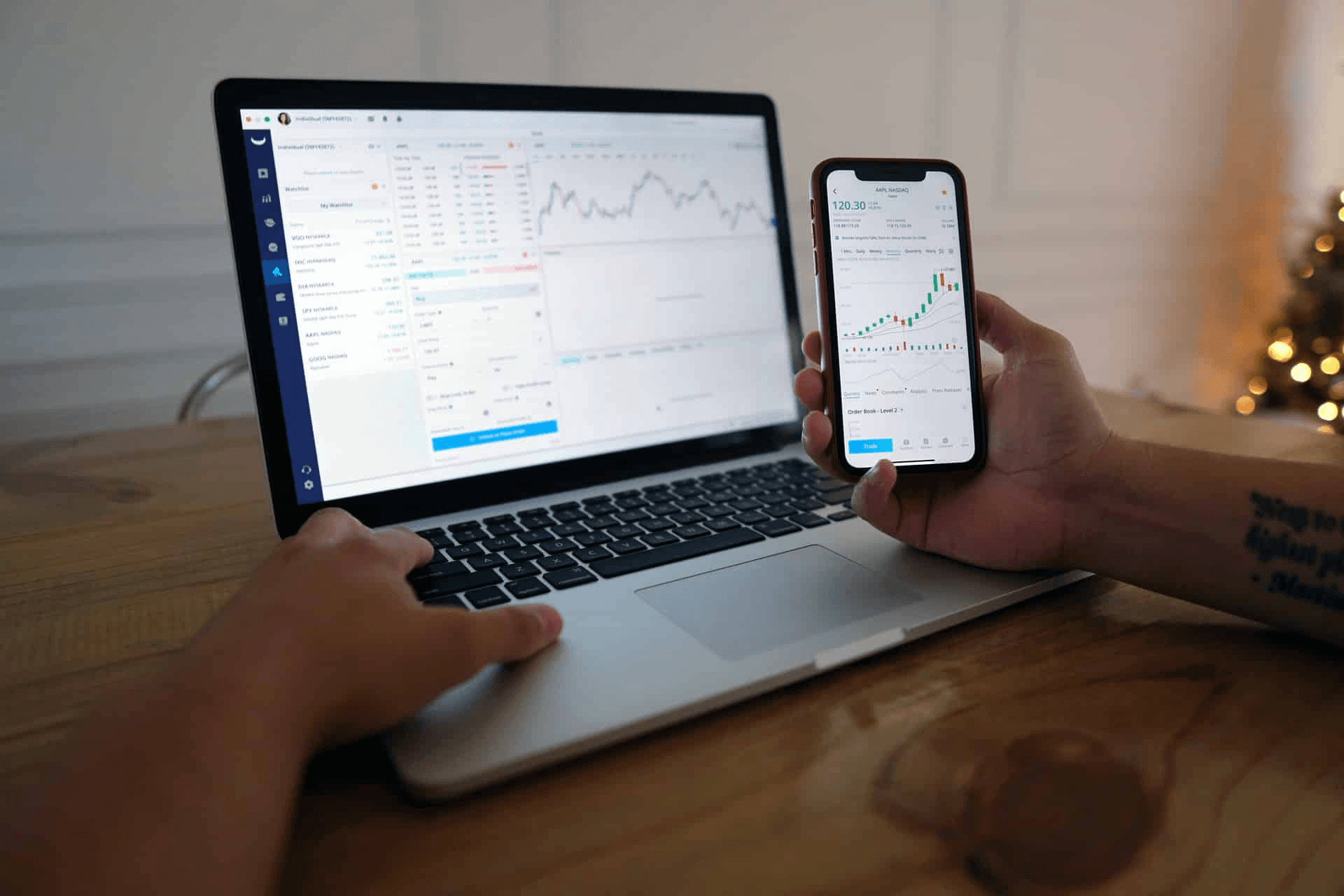 Person trading stocks on phone and laptop - Onchain Analytics for Beginners