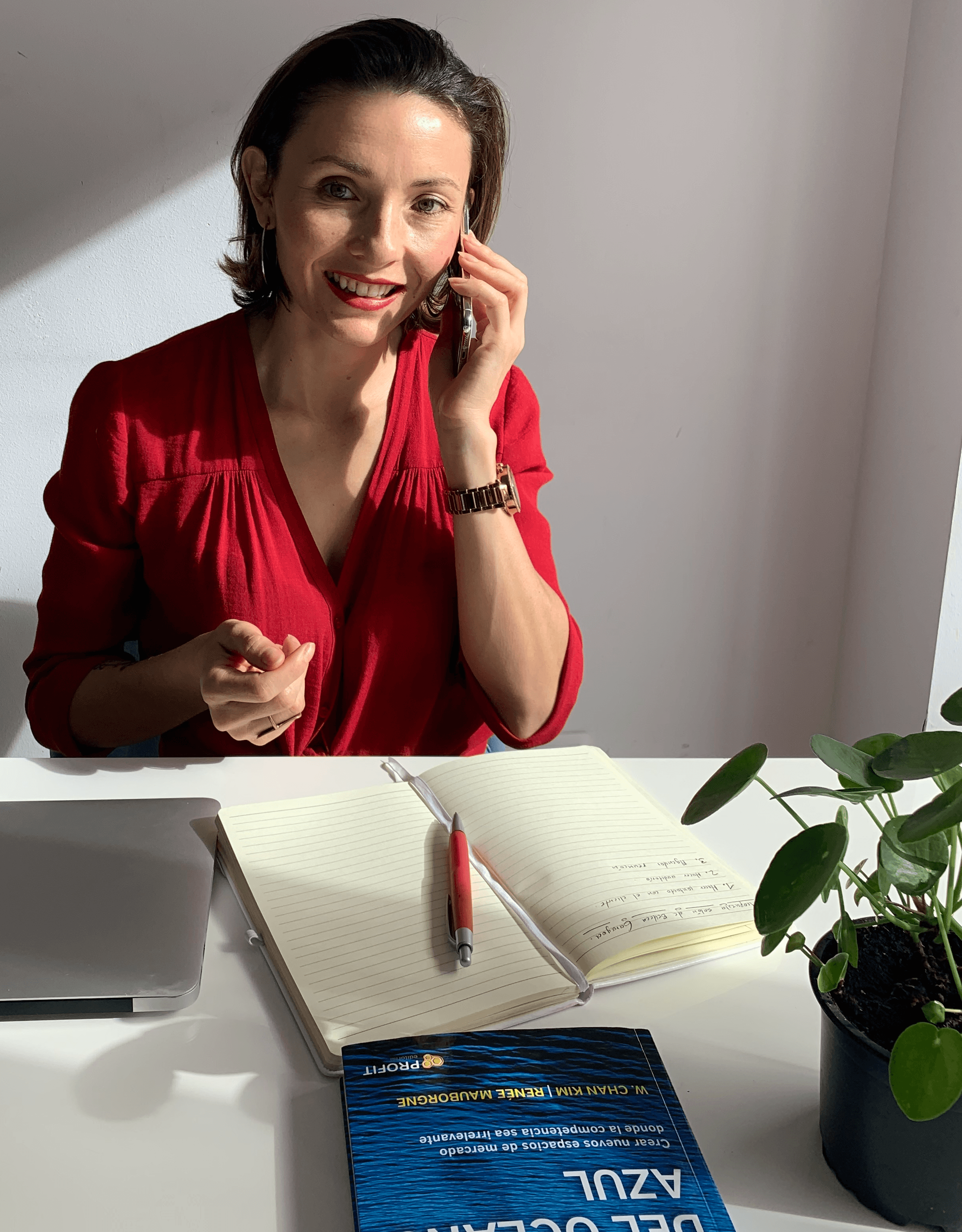 Thoughtful young man in a white shirt and glasses against a plain background.