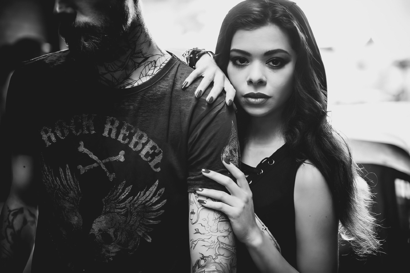 woman in gray and white polka dot blazer standing and smiling