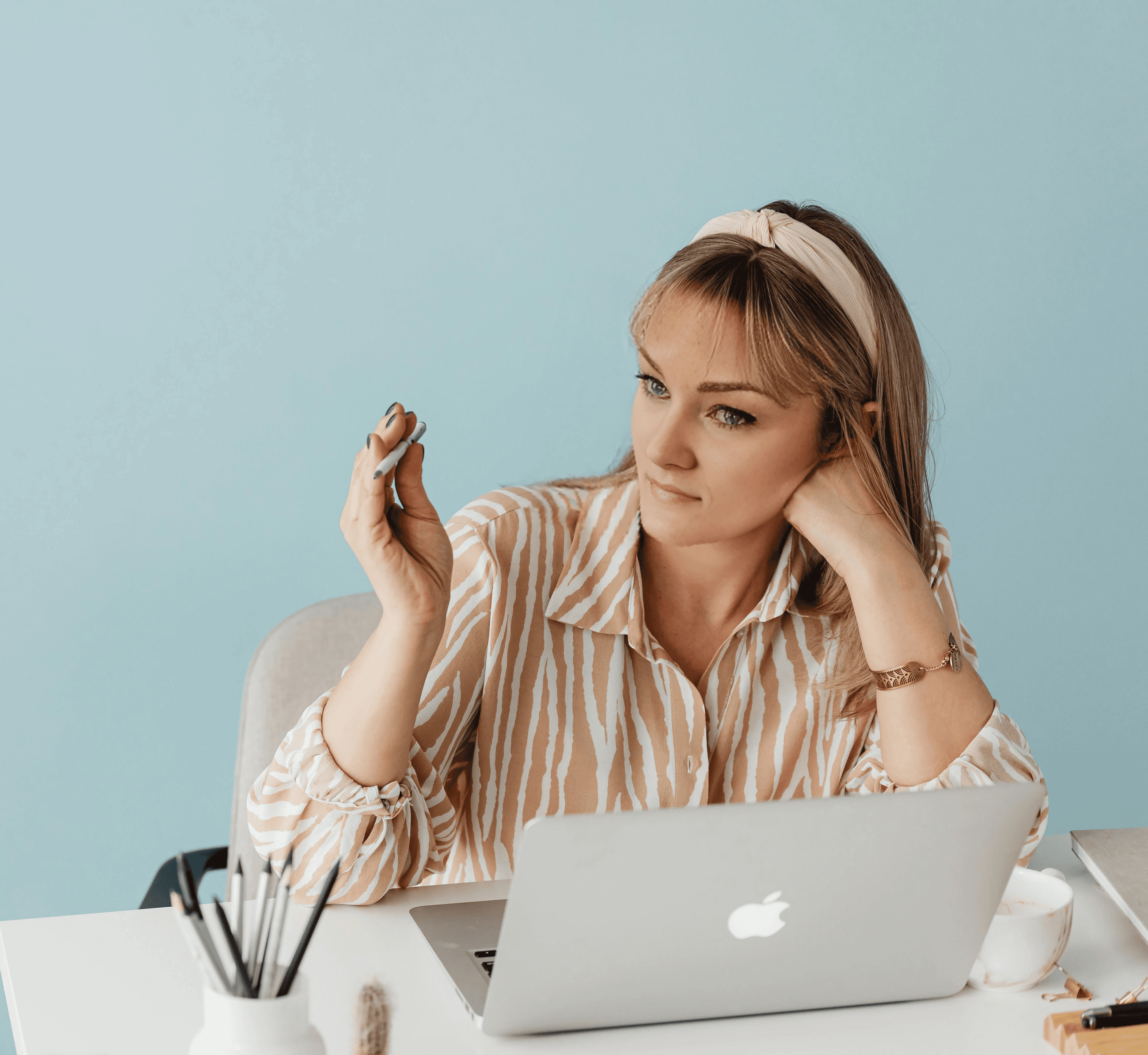 woman sitting around table holding tablet